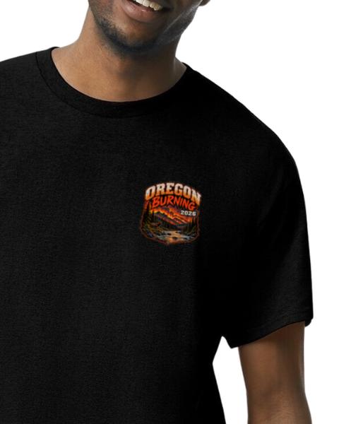 A close-up of a man wearing a black short-sleeve t-shirt with a small 'Oregon Burning' graphic printed on the left chest.